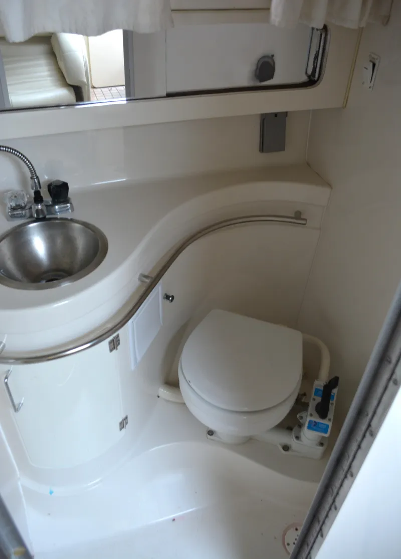 Slide: The Image of 1998 Monterey 296 Cruiser bathroom with sink and toilet, compact and functional design. - 10