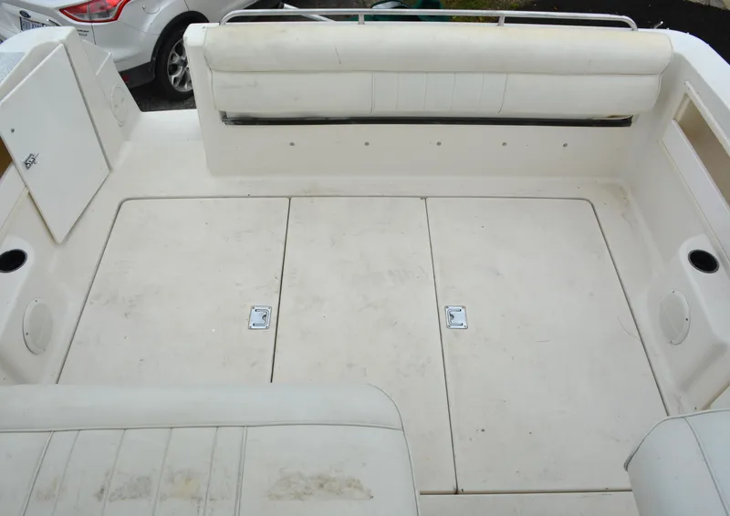 Slide: The Image of 1998 Monterey 296 Cruiser boat deck with white seating and storage compartments. - 12