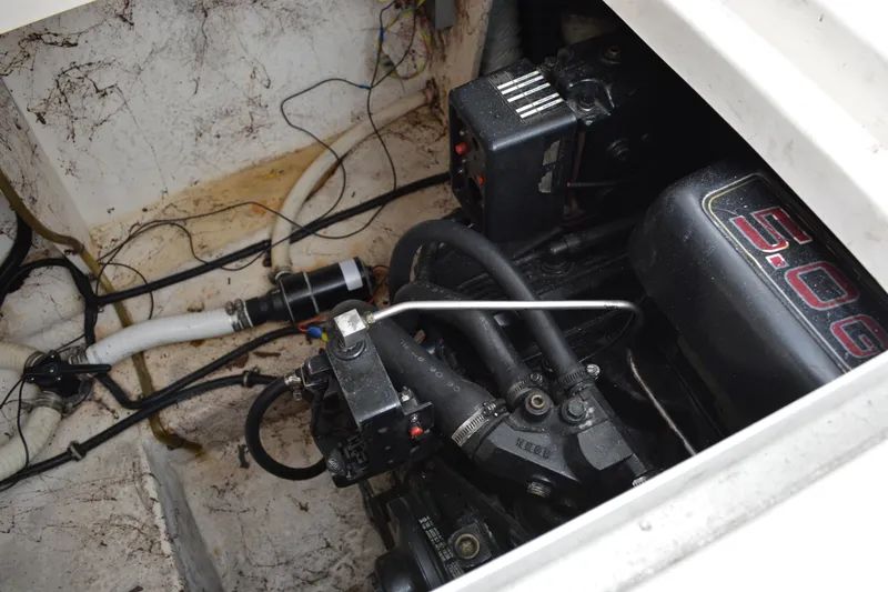Slide: The Image of Engine compartment of a 1998 Monterey 296 Cruiser boat, showing mechanical components and wiring. - 15