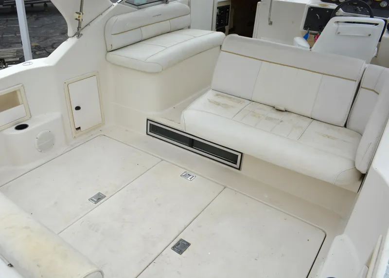 Slide: The Image of 1998 Monterey 296 Cruiser interior with white seating and storage compartments. - 2