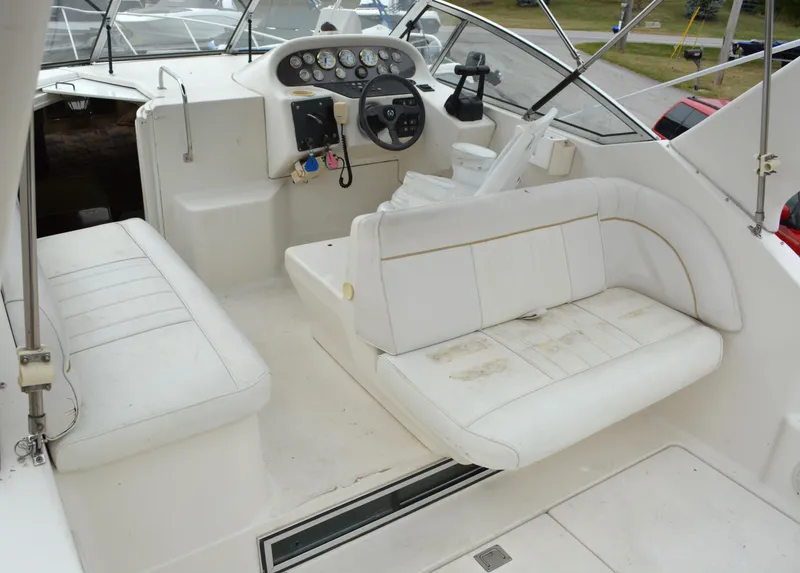 Slide: The Image of 1998 Monterey 296 Cruiser interior with white seating and control panel. - 3