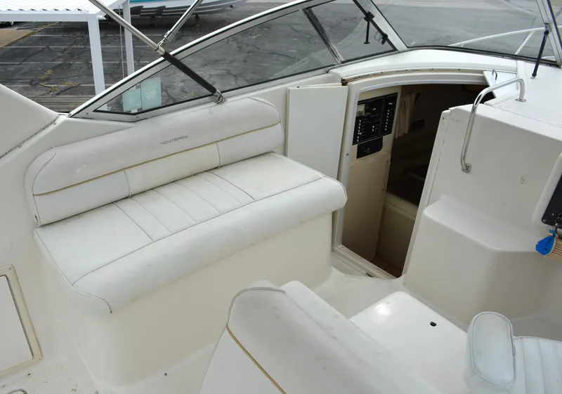 Slide: The Image of 1998 Monterey 296 Cruiser interior with white seating and cabin entrance. - 4