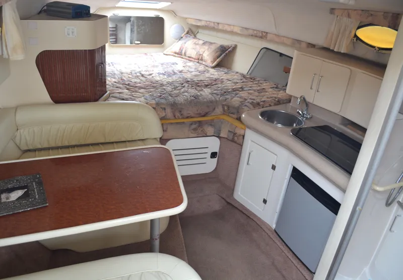 Slide: The Image of Interior of 1998 Monterey 296 Cruiser with bed, kitchenette, and dining area. - 6