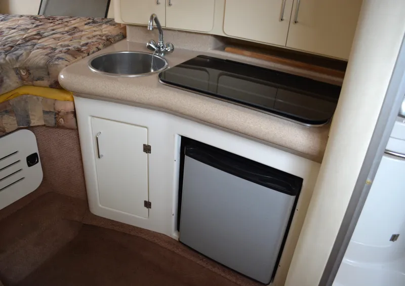 Slide: The Image of 1998 Monterey 296 Cruiser interior with kitchenette, sink, and mini fridge. - 8