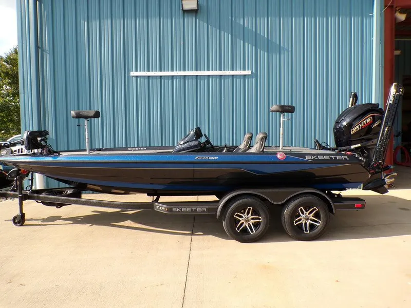 The Image of 2025 Skeeter ZXR20 bass boat with dual axle trailer, parked outdoors. - 1