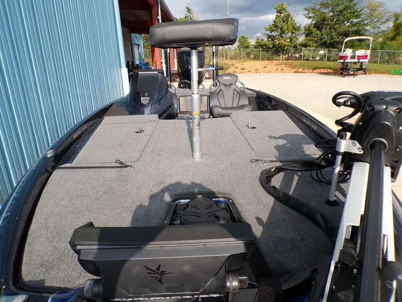 Slide: The Image of 2025 Skeeter ZXR20 boat deck with seating and equipment, parked outdoors. - 16