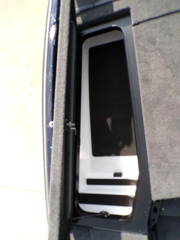 Slide: The Image of 2025 Skeeter ZXR20 boat storage compartment with carpeted interior. - 19