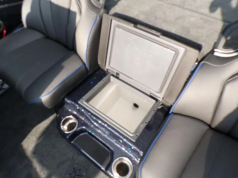 Slide: The Image of 2025 Skeeter ZXR20 interior with open storage compartment and cup holders. - 24