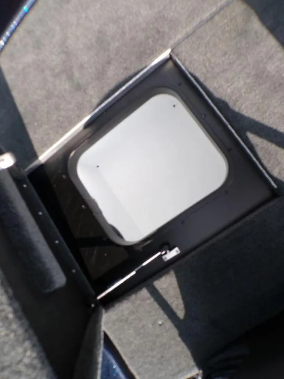 Slide: The Image of 2025 Skeeter ZXR20 boat storage compartment with carpeted interior. - 26