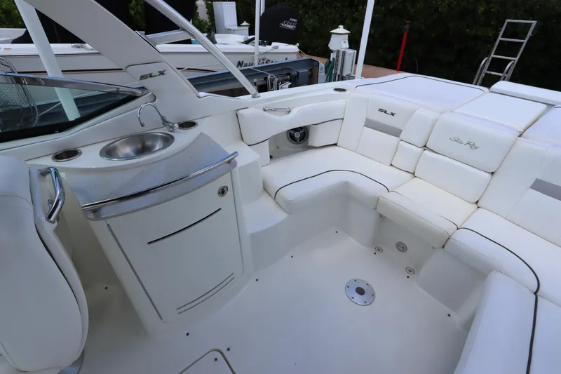 Slide: The Image of Interior of a 2009 Sea Ray 270 Select EX with white upholstery and sink. - 15