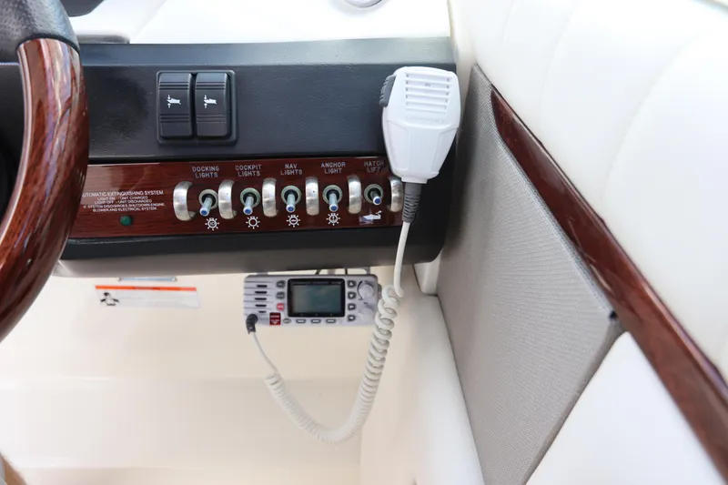 Slide: The Image of Sea Ray 270 Select EX 2009 control panel with switches and radio. - 30