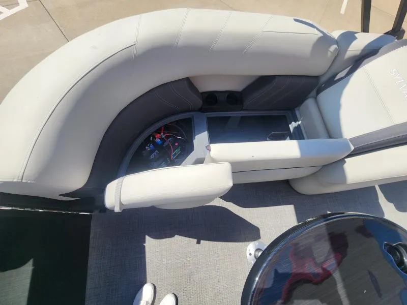 Slide: The Image of 2024 Sylvan Mirage X3 boat interior with plush seating and storage compartment. - 11