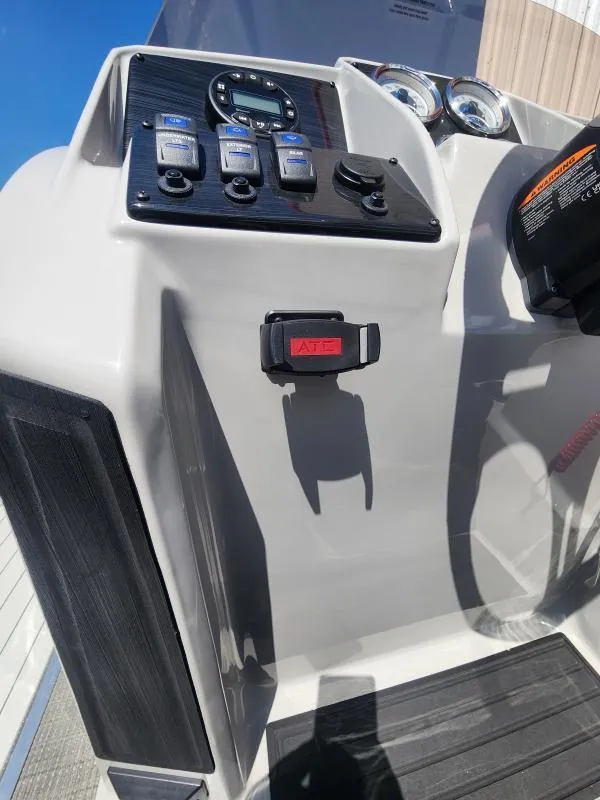 Slide: The Image of 2024 Sylvan Mirage X3 boat dashboard with controls and gauges. - 12