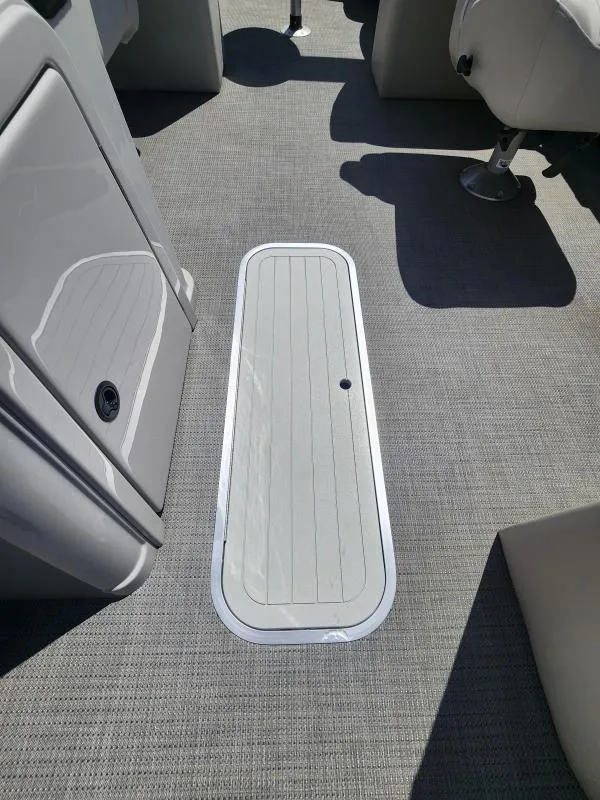 Slide: The Image of 2024 Sylvan Mirage X3 boat interior with gray flooring and seating. - 18