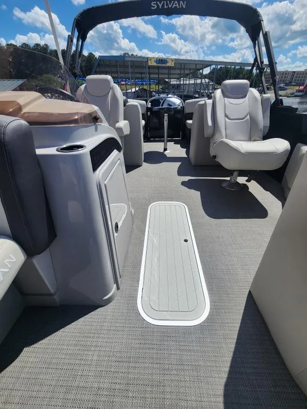 Slide: The Image of 2024 Sylvan Mirage X3 pontoon boat interior with plush seating and modern design. - 20