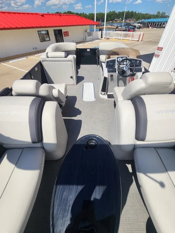 Slide: The Image of 2024 Sylvan Mirage X3 boat interior with plush seating and modern dashboard. - 22