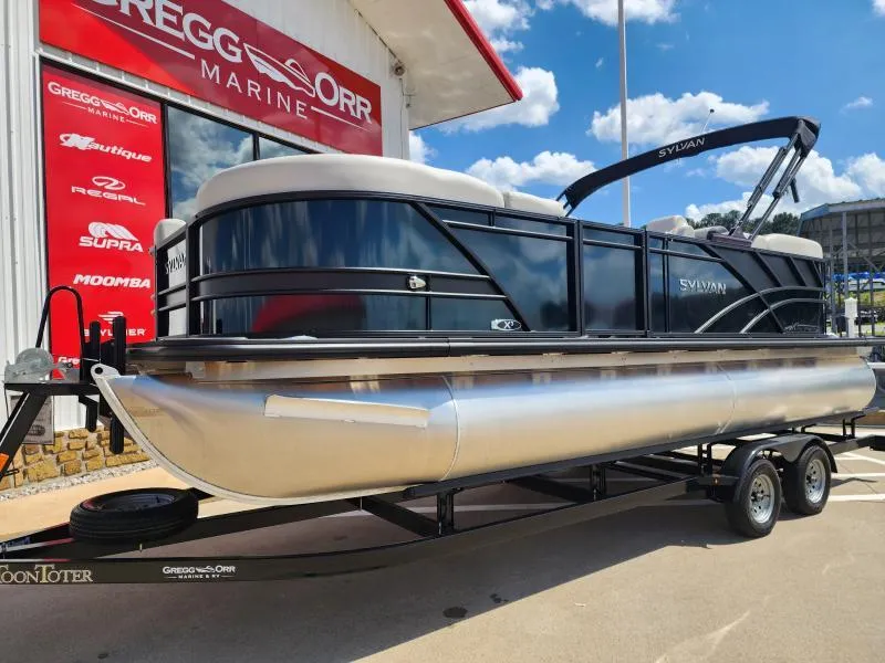 Slide: The Image of 2024 Sylvan Mirage X3 pontoon boat on trailer at Gregg Orr Marine dealership. - 3