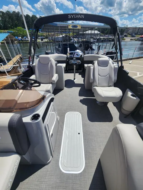 Slide: The Image of 2024 Sylvan Mirage X3 pontoon boat interior with plush seating and modern design. - 7