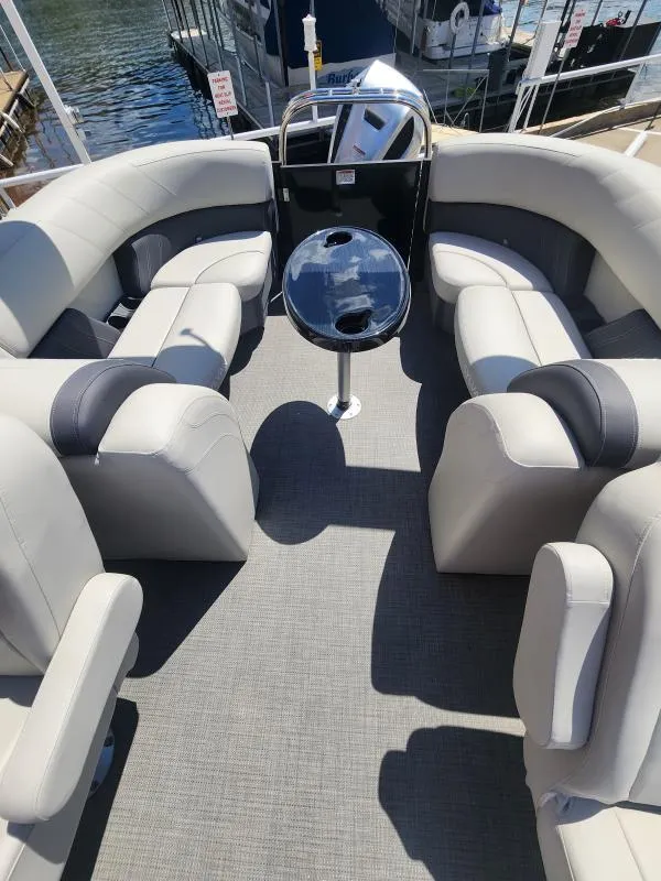 Slide: The Image of 2024 Sylvan Mirage X3 pontoon boat interior with plush seating and central table. - 8
