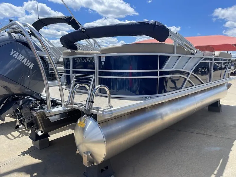 Slide: The Image of 2024 Sylvan Mirage 8524 LZ pontoon boat with Yamaha engine, docked under blue sky. - 3