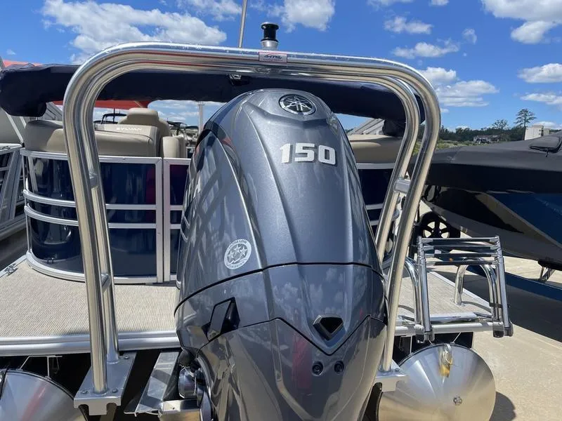 Slide: The Image of 2024 Sylvan Mirage 8524 LZ pontoon boat with 150 HP engine, docked under blue sky. - 6