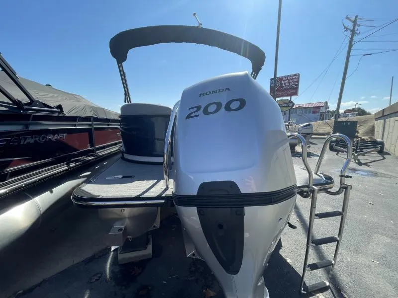 Slide: The Image of 2024 Starcraft SLS-3 boat with Honda 200 outboard motor, docked outdoors. - 4