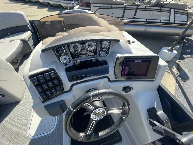 Slide: The Image of 2024 Starcraft SLS-3 boat dashboard with steering wheel and control panel. - 7