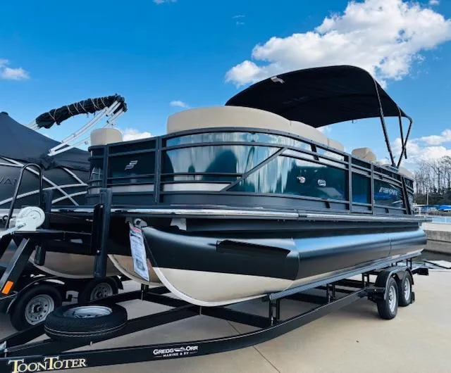 Slide: The Image of 2024 Starcraft SLS-3 pontoon boat on trailer under blue sky. - 1