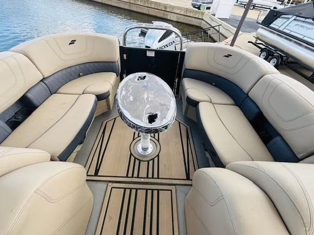 Slide: The Image of 2024 Starcraft SLS-3 boat interior with beige seating and a central table. - 13