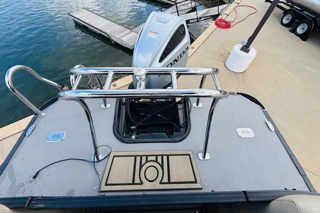 Slide: The Image of 2024 Starcraft SLS-3 boat with Honda outboard motor at dockside. - 14