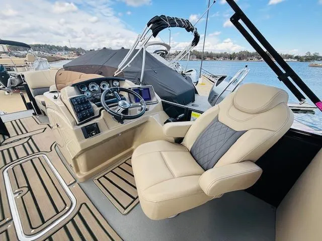 Slide: The Image of 2024 Starcraft SLS-3 boat interior with captain's chair and control panel. - 16