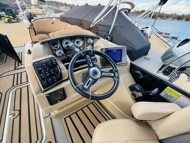 Slide: The Image of 2024 Starcraft SLS-3 boat dashboard with steering wheel and control panel. - 17