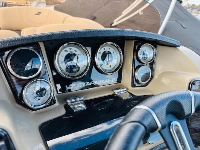 Slide: The Image of Dashboard of 2024 Starcraft SLS-3 boat with gauges and steering wheel. - 18