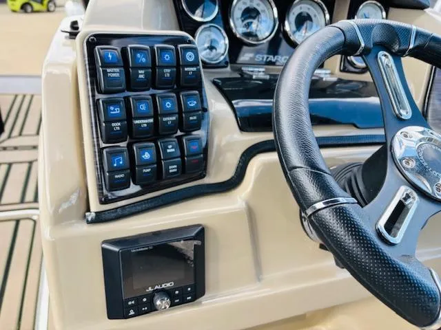 Slide: The Image of 2024 Starcraft SLS-3 boat dashboard with control panel and steering wheel. - 19