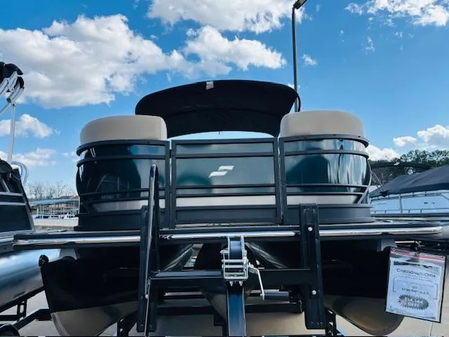 Slide: The Image of 2024 Starcraft SLS-3 pontoon boat on trailer under blue sky. - 2