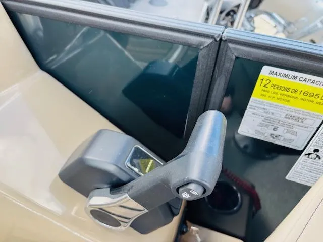 Slide: The Image of 2024 Starcraft SLS-3 boat throttle control and capacity label. - 21