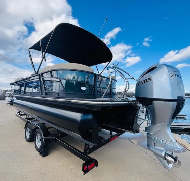 Slide: The Image of 2024 Starcraft SLS-3 pontoon boat with Honda 200 outboard motor on trailer. - 4