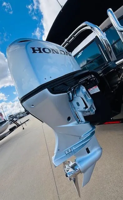 Slide: The Image of 2024 Starcraft SLS-3 boat with Honda outboard motor, docked under a blue sky. - 6