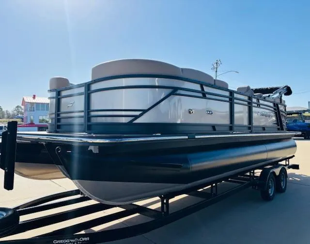 Slide: The Image of 2024 Starcraft SLS-3 pontoon boat on trailer, sleek design, sunny day. - 1