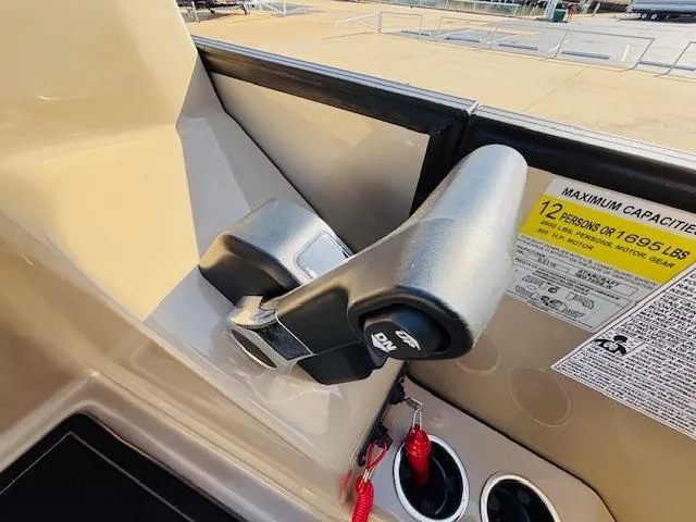 Slide: The Image of 2024 Starcraft SLS-3 boat throttle control with capacity label for 12 persons or 1695 lbs. - 11