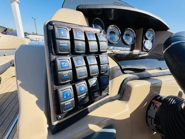Slide: The Image of 2024 Starcraft SLS-3 boat dashboard with control panel and gauges. - 12