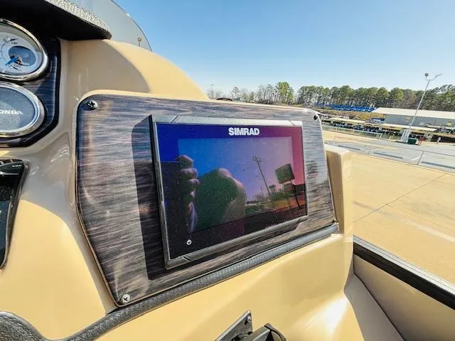 Slide: The Image of Simrad display on 2024 Starcraft SLS-3 boat dashboard, sunny day, outdoor setting. - 14