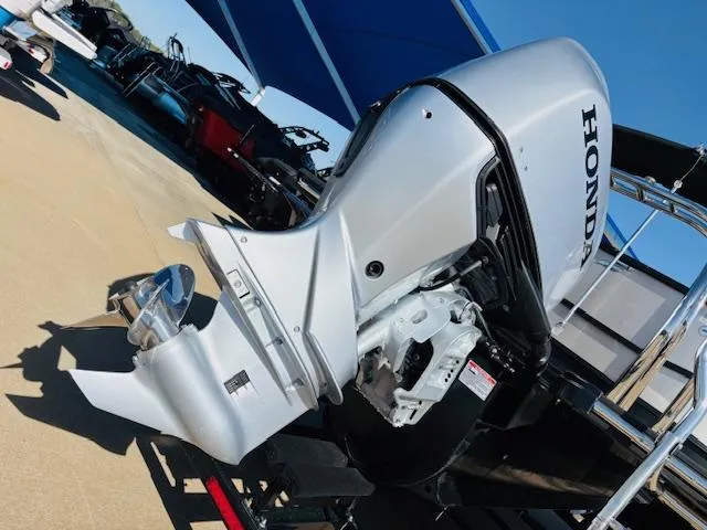 Slide: The Image of 2024 Starcraft SLS-3 boat with Honda outboard motor, displayed outdoors. - 18