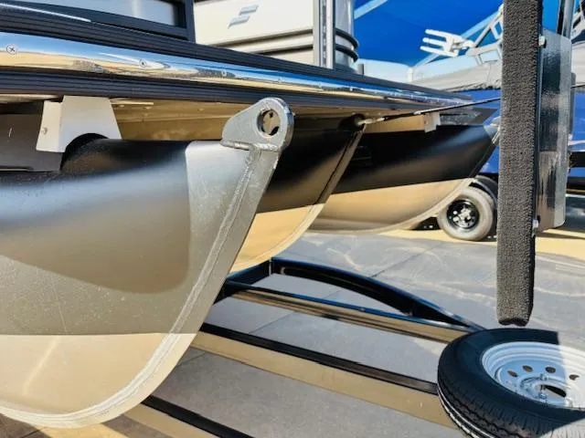 Slide: The Image of 2024 Starcraft SLS-3 pontoon boat trailer detail with wheels and metal frame. - 19