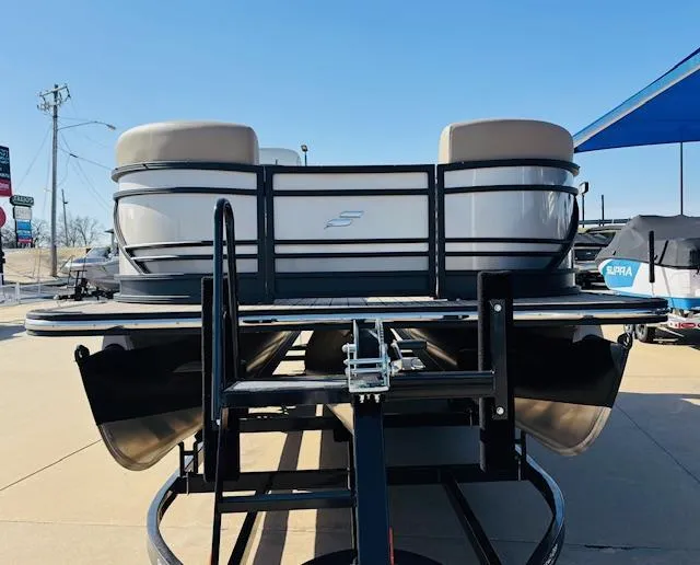 Slide: The Image of 2024 Starcraft SLS-3 pontoon boat on trailer under clear blue sky. - 2