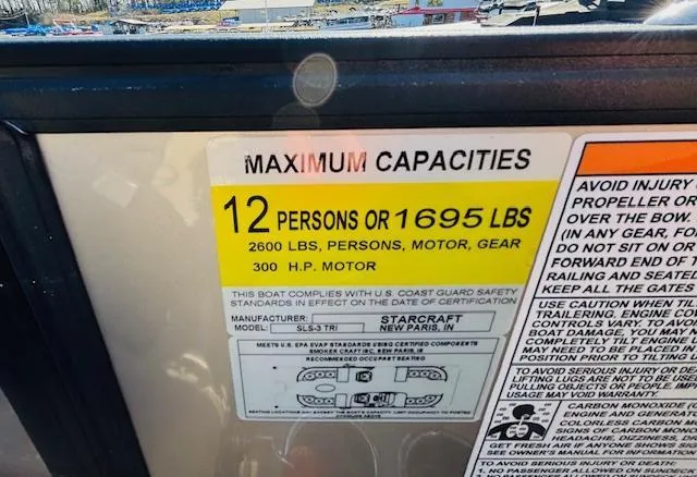 Slide: The Image of 2024 Starcraft SLS-3 boat capacity label: 12 persons or 1695 lbs, 300 HP motor. - 20