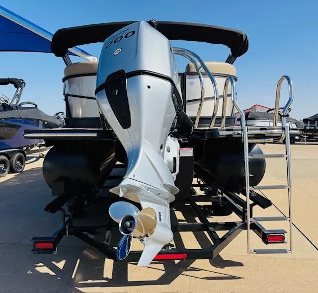 Slide: The Image of 2024 Starcraft SLS-3 pontoon boat with powerful outboard motor and ladder, displayed outdoors. - 5