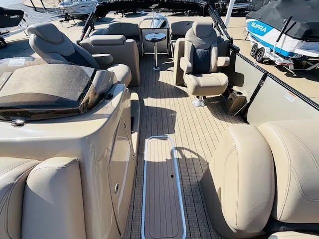 Slide: The Image of 2024 Starcraft SLS-3 boat interior with beige seating and wood-style flooring. - 7