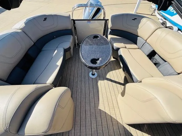 Slide: The Image of 2024 Starcraft SLS-3 boat interior with beige seating and a central table. - 8