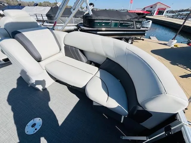 Slide: The Image of 2024 Sylvan Mirage 8522 LZ pontoon boat with luxurious seating at a marina. - 11